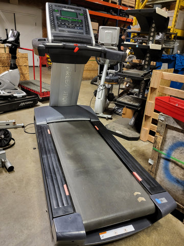 Close-up of the Freemotion t10.9b treadmill electronic interface showcasing the bright REFLEX LED workout metric display and control buttons.