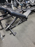 Hammer Strength HDADJ heavy-duty commercial bench adjusted to an incline position for lifting.