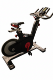 Profile view of the Life Fitness IC5 indoor cycle spin bike featuring a sleek black frame, red accents, and a rear-mounted aluminum flywheel