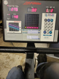 Close-up view of the Life Fitness Lifecycle 9100 electronic console featuring the central LED alphanumeric grid display screen, push-button control keys, and integrated reading rack