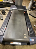  An athlete running on the Freemotion t10.9b Commercial Treadmill inside a modern fitness center environment.