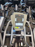 Close-up view of the SCIFIT SXT7000 Intelli-Fit 7-inch LCD console display, showing the tactile keypad layout, workout profile matrix, and metrics readouts for time, distance, and calories.