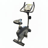 Profile view of a self-powered SportsArt C535U commercial upright cycle featuring a silver steel frame, low step-through shroud, and black console.