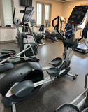 Star Trac 8 Series Elliptical side profile showing moving arms and large foot platforms