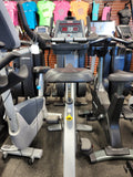 The adjustable ratchet seat mechanism on a silver Star Trac Pro exercise bike.