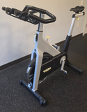High-quality dual-sided SPD pedals on the Technogym D92 spin bike, mounted on a rust-resistant, sandblasted steel frame. 