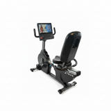  Side profile of the True Fitness R900 commercial recumbent bike showing the step-through design, adjustable mesh seat, and steel frame.