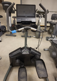 Side view of the TRUE Fitness LateralX lateral cross trainer highlighting the heavy-gauge steel frame architecture, front-drive flywheel system, and low-impact multi-planar foot pedals.