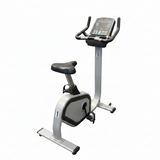 Profile view of a heavy-duty commercial Tuff Stuff CTS 300UB upright stationary exercise bike with a silver steel frame and black shroud components.